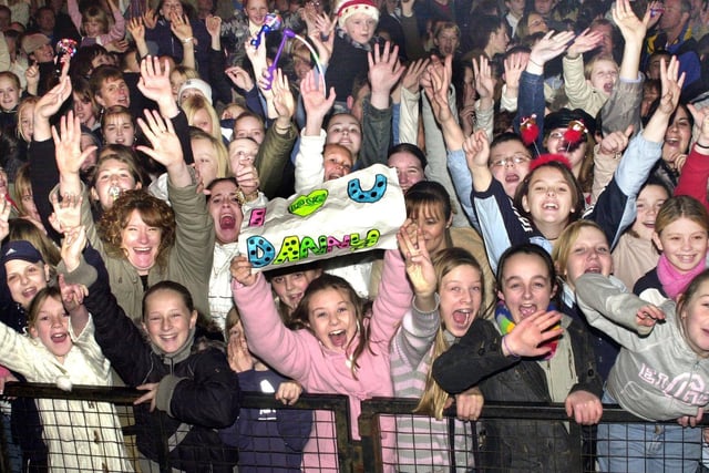 McFly fans at the front of a 7,000 strong crowd in Wigan Market Place to watch McFly turn on the Christmas lights and perform on stage in 2004.