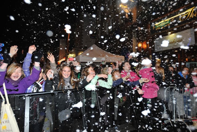 The crowd covered in fake snow at the Christmas light switch on celebrations 2010.