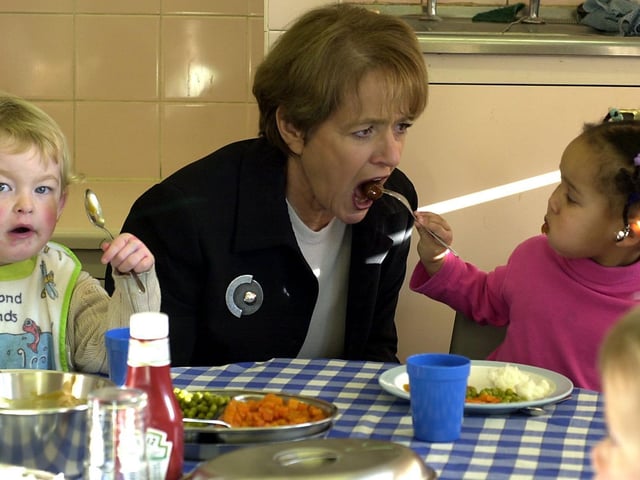 Children's Minister Margaret Hodge is fed a meatball by two-year-old Simone Dawesduring her visit to the Parklands Children's Centre at Seacroft.