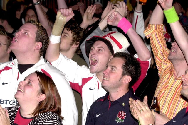 England rugby fans at the Walkabout bar in Leeds city centre celebrate victory against Australia in the World Cup final.