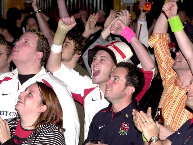 England rugby fans at the Walkabout bar in Leeds city centre celebrate victory against Australia in the World Cup final.