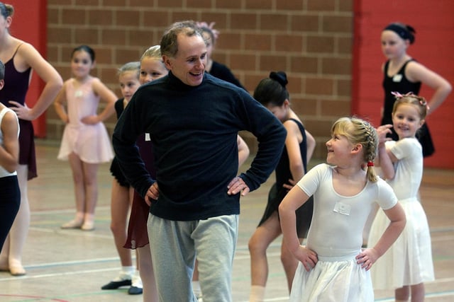 Dance star Wayne Sleep jokes with a young ballet dancer at his ballet workshop at the Leeds University Sports Centre.