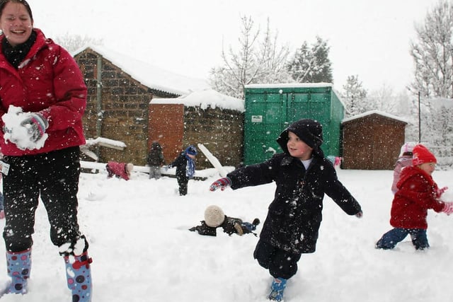 Children and staff at Crigglestone nursery play in the snow.