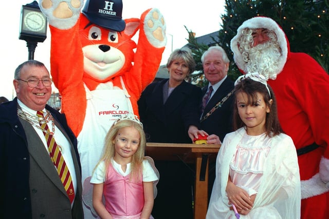 Cleveleys Christmas lights were officially switched on by Mayor of Wyre Cllr. Harry Taylor on 1999. Pic L-R: President Council of Trade Brian Ward, Fairclough Homes (lights sponsors) mascot Homer, Yasmin Wyers-Roebuck, Jackie Matheson  Mayor of Wyre Cllr. Harry Taylor, 9 year-old Sarah Bittley and Father Christmas.