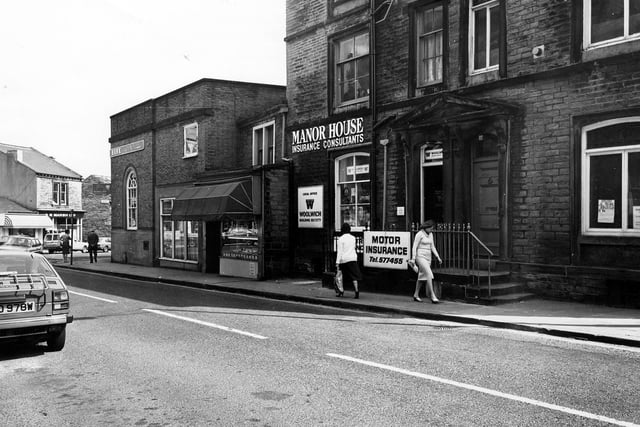 April 1982. Pudsey's Manor House Street showing from left Barclays Bank, then W.H. Bowman, butchers, Manor House insurance consultants. On the right is the offices of St. John's Ambulance Brigade.