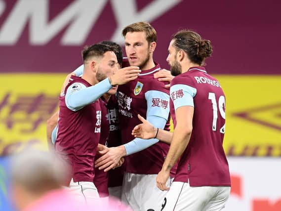 Chris Wood of Burnley celebrates with Dwight McNeil and Jay Rodriguez after scoring their team's first goal during the Premier League match between Burnley and Crystal Palace at Turf Moor on November 23, 2020 in Burnley, England.