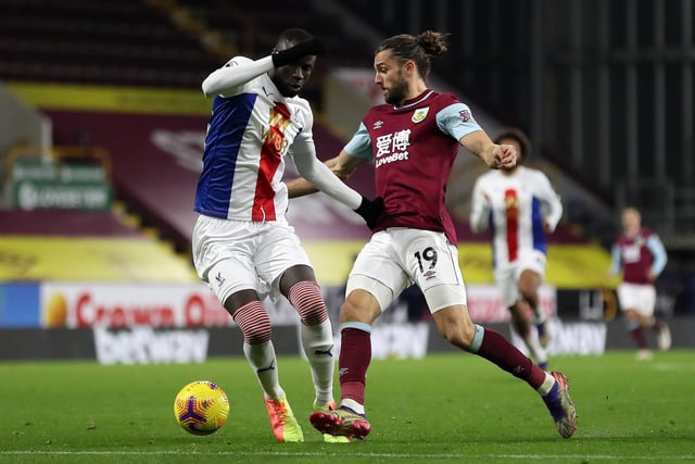 Jay Rodriguez of Burnley is challenged by Cheikhou Kouyate of Crystal Palace during the Premier League match between Burnley and Crystal Palace at Turf Moor on November 23, 2020 in Burnley, England.