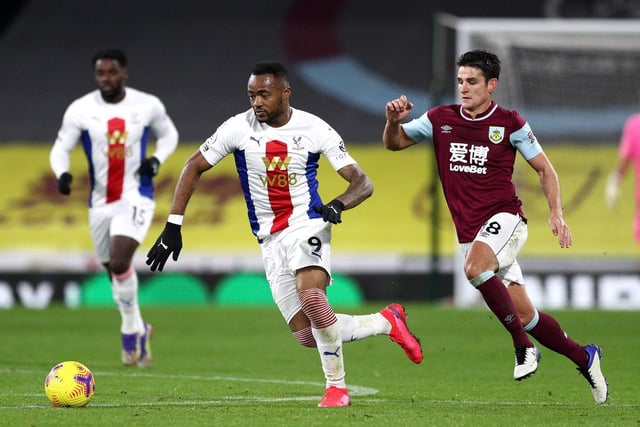 Jordan Ayew of Crystal Palace is challenged by Ashley Westwood of Burnley during the Premier League match between Burnley and Crystal Palace at Turf Moor on November 23, 2020 in Burnley, England.