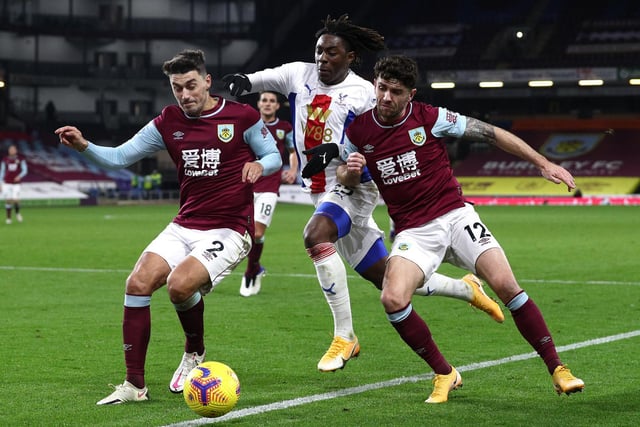 Eberechi Eze of Crystal Palace is challenged by Matthew Lowton and Robbie Brady of Burnley during the Premier League match between Burnley and Crystal Palace at Turf Moor on November 23, 2020 in Burnley, England.