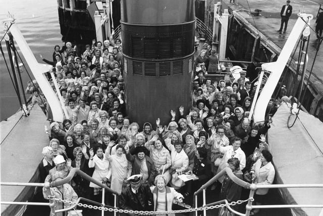 All aboard... and happy smiles and waves from Women's Circle members on the ferry as they leave Gourock for the trip across to Dunoon in July 1974.