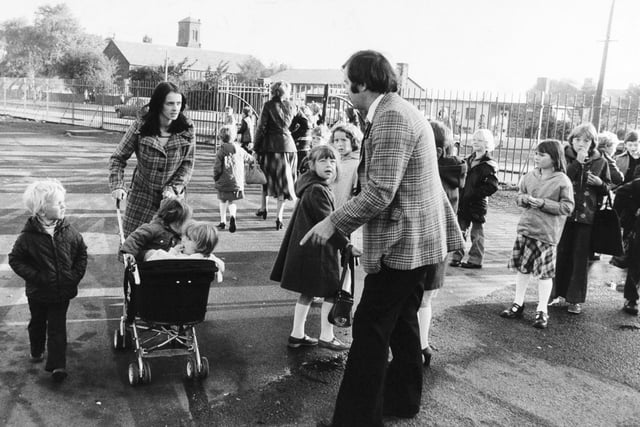 Teachers tell children arriving with parents at Middleton Primary School to go home. The school has been the traget of arsonists in October 1979.