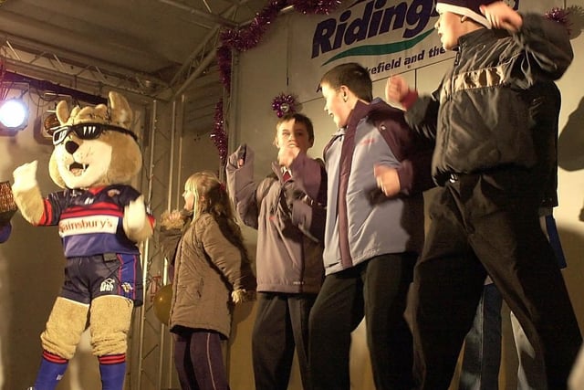 Wakefield Trinity Wildcats mascot 'Daddy Cool' dancing on stage with members of the crowd in 2004.
