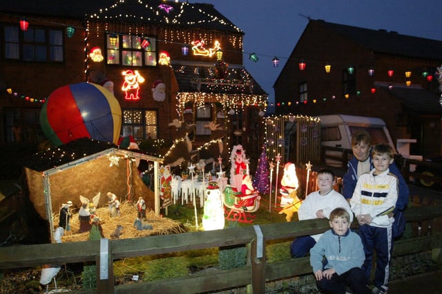 Linda Knight is pictured with local children showing off her Christmas light at her Hebden Bridge home in 2003.