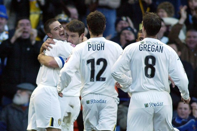 David Healy celebrates with his teammates after chipping in to level seven minutes later.