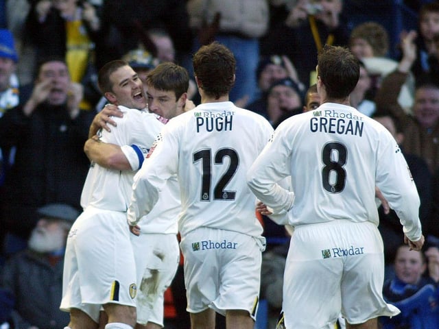David Healy celebrates with his teammates after chipping in to level seven minutes later.