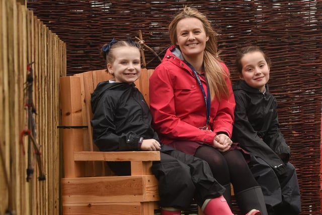Teacher Kim Leathley enjoys some quiet time with year three pupils  Saffron  and Lexi