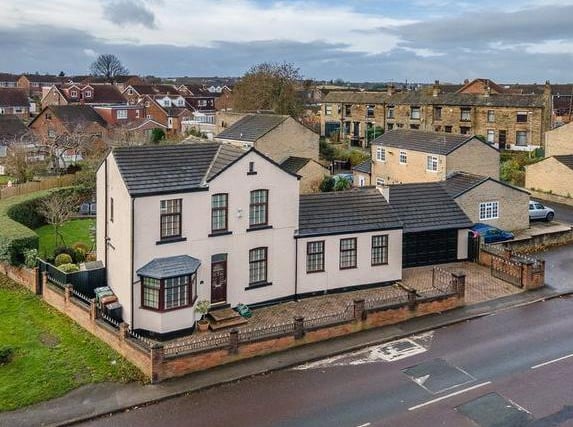 This impressive detached property sits in Church Street in Gildersome. It has a large kitchen diner as well as three reception rooms and an office.