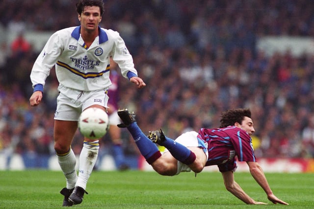 Gary Speed watches Dean Saunders take a tumble during Leeds United's clash with Aston Villa in April 1995.