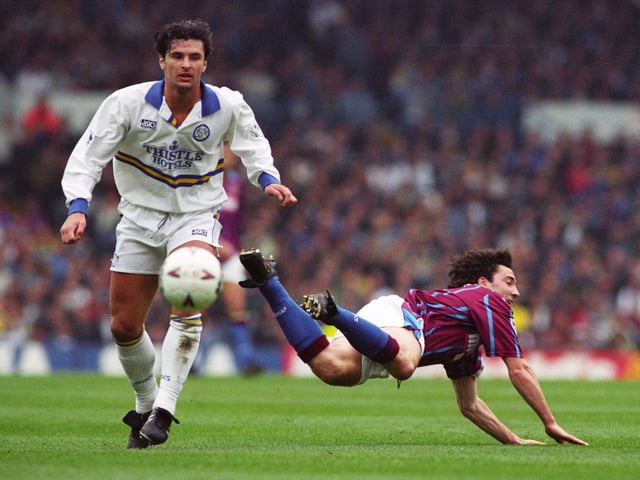 Gary Speed watches Dean Saunders take a tumble during Leeds United's clash with Aston Villa in April 1995.