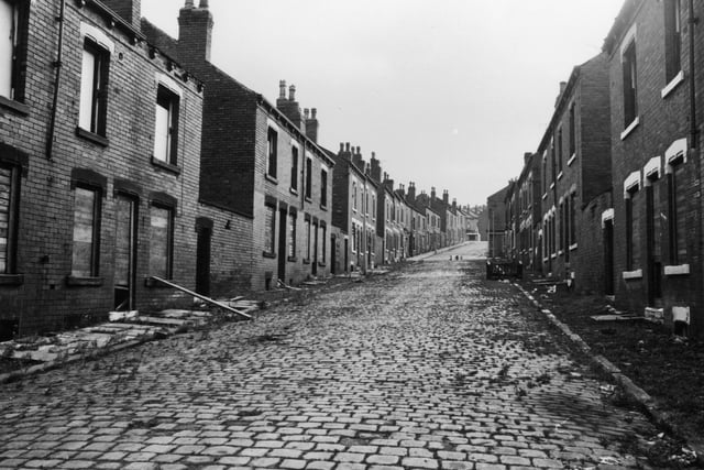 Circa 1975. This photo shows an unidentified street of terraced housing in the Beeston area. Windows are boarded up and it is due for demolition as part of slum clearance.