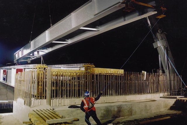 Vital connection: Installing the bridge across the railway line in 2001 to open up the southern half of the site.