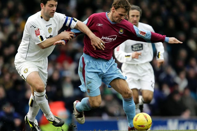 Paul Butler and Teddy Sheringham tussle for the ball.