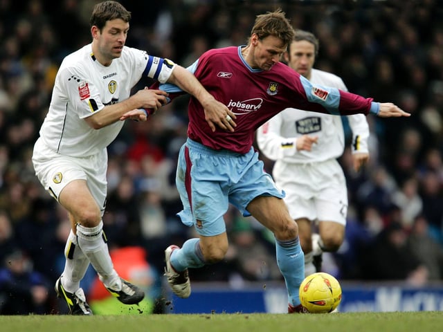 Paul Butler and Teddy Sheringham tussle for the ball.