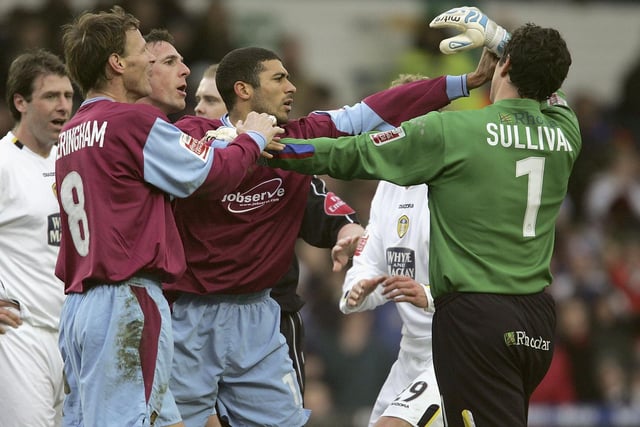 West Ham United's Hayden Mullins clashes with Leeds United goalkeeper Neil Sullivan.