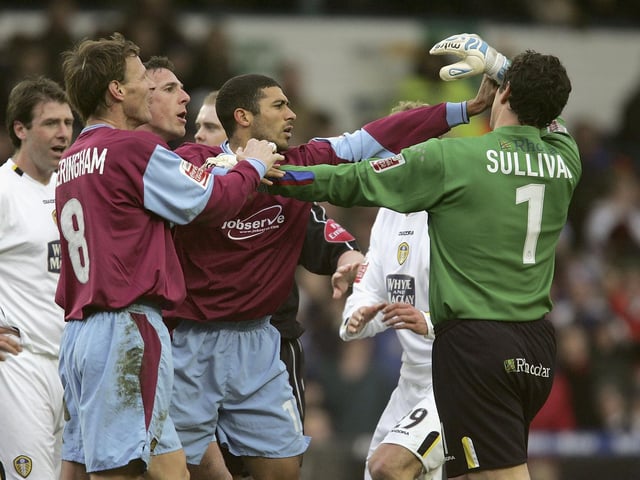 West Ham United's Hayden Mullins clashes with Leeds United goalkeeper Neil Sullivan.