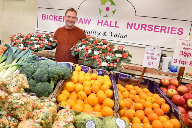 Richard Holme from Bickershaw Hall Nurseries fruit, veg and flower stall at Wigan Indoor Market.