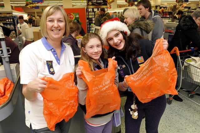 Guide Leader Judith Kershaw with guides Lucy Spencer and Emily Watkinson, of the 1st Scarborough Guides, help shoppers pack their bags at Sainsbury’s.