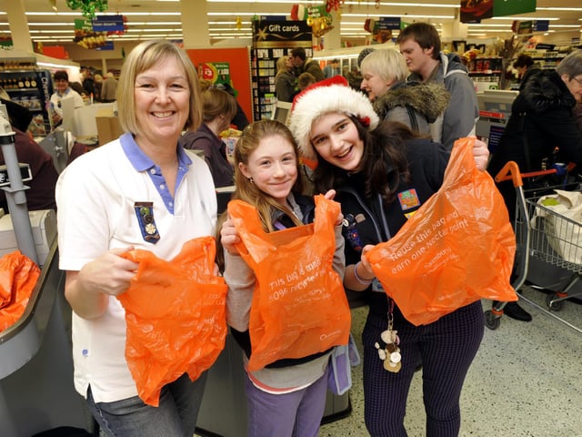 Guide Leader Judith Kershaw with guides Lucy Spencer and Emily Watkinson, of the 1st Scarborough Guides, help shoppers pack their bags at Sainsbury’s.