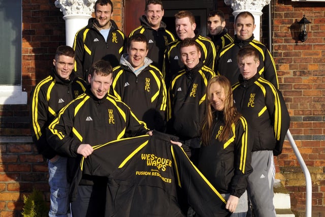 Cher Atkinson (front right), branch manager of Fusion Resources, presents Westover Wasps FC, with their new training tops, sponsored by her company.