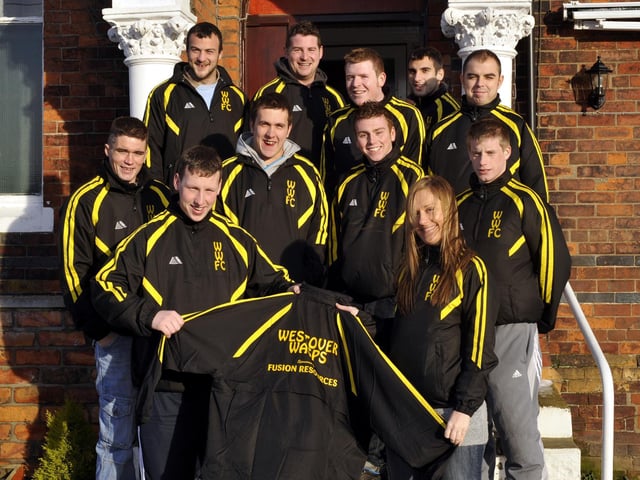Cher Atkinson (front right), branch manager of Fusion Resources, presents Westover Wasps FC, with their new training tops, sponsored by her company.