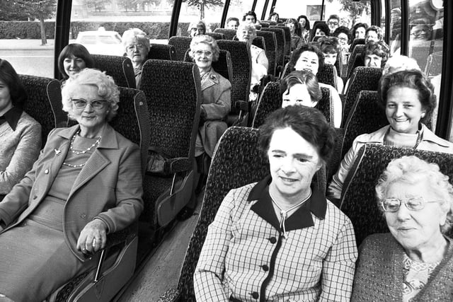Members of Wigan Ladies Cirlce board their coach for another day trip from Wigan market square in 1976