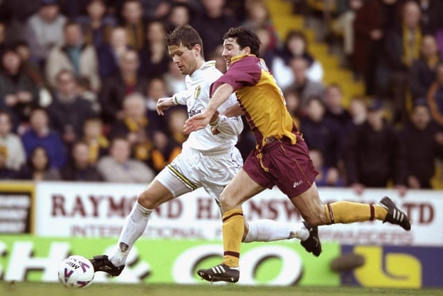 Eirik Bakke holds off the challenge of Bradford City striker Dean Saunders during the FA Carling Premiership match at Valley Parade in March 2000. Leeds won 2-1 thanks to a brace from Michael Bridges.