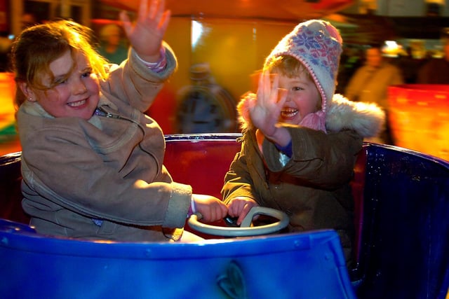 Olivia and Abby enjoy one of the fairground rides before Castleford lights switch on, November 2005.