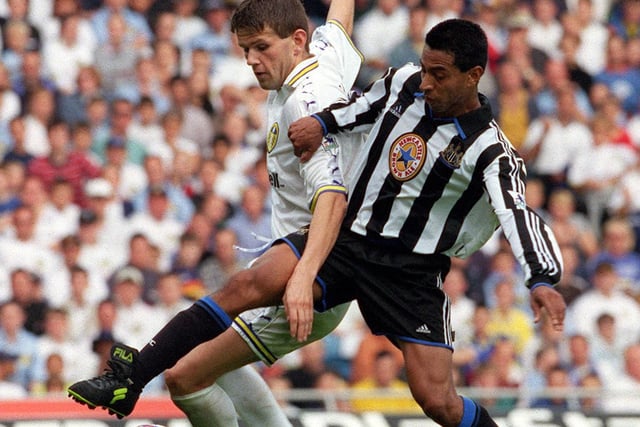Eirik Bakke holds off a challenge from Newcastle Uniuted's Nolberto Solano.