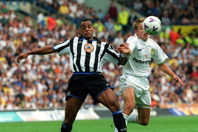 Newcastle United's Alain Goma tries to hold off the challenge from Alan Smith.