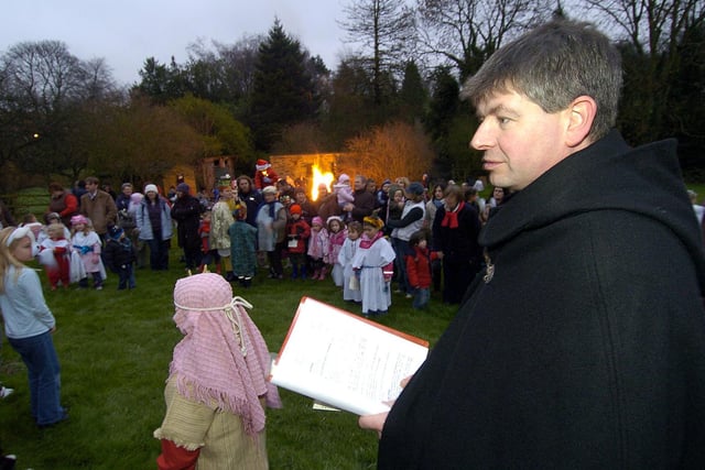 Rev Alistair Fearnley narrates Scalby nativity to the crowd.