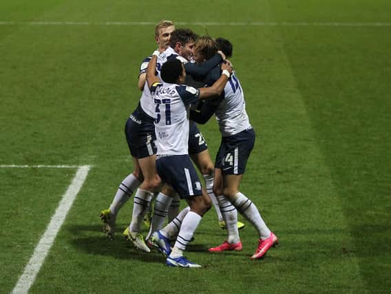 Preston players celebrate the opening goal.
