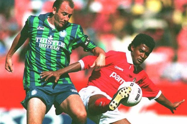 Gary McAllister tussles with Benfica's Filho Valdo during an exhibition match at Ellis Park in Johannesburg.