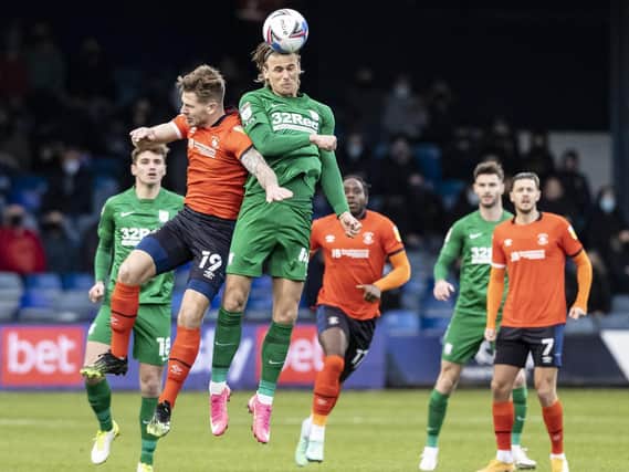 Preston midfielder Brad Potts challenges in the air
