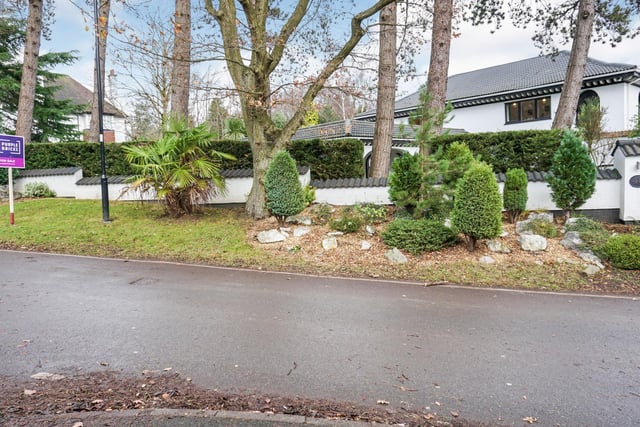 The property is entered via a long driveway which leads to a double garage.