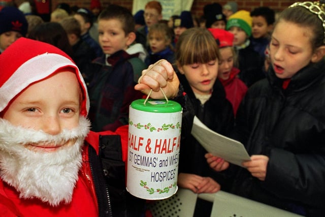 Christmas 1997 and mini Santa George Brookes and other children from Mount St. Mary's Primary School sang carols at Leeds Bus Station in aid of the YEP's Half and Half Appeal