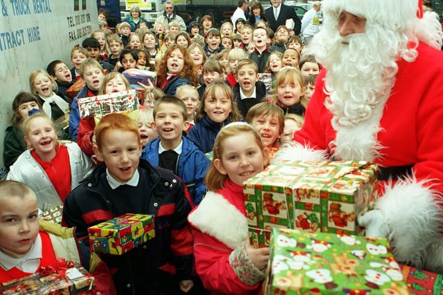 Last minute loading of shoeboxes to Father Christmas by pupils at Armley Primary School before a charity convoy set off to Romania in 1998.