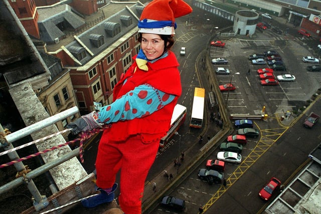 This is Fleur Robinson who was living life on the edge at Christmas in 1996 to raise money for charity. She is pictured in her pixie outfit at the start of her abseil from the roof of the Queens Hotel in City Square.
