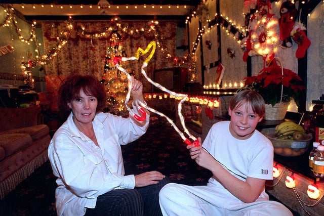 Christmas 1997 and pictured is Elaine Idle with her son Jay inside the front room of their home at New Farnley in Leeds. Elaine spent over two weeks putting up over 2,500 Christmas lights inside and outside her house.