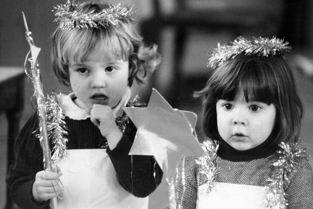1981 and Lyndsey Barron (left) and Emma Sutcliffe, who play fairy dolls in their school's Christmas concert, look just a little bewildered by the whole thing as they take part in rehearsals.
