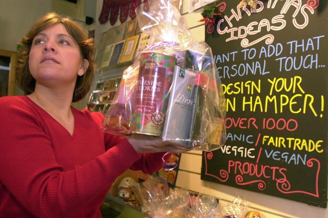 2003 and Bev Jacques manager at Out of this World in the city centre is pictured with one of the ethical Christmas hampers containing fair trade goods on sale at the shop.